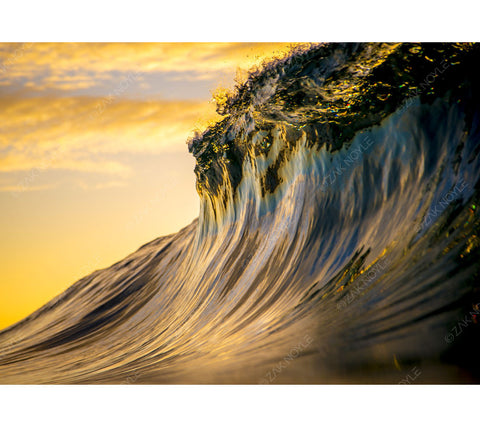 Sunset reflection off of a glassy wave by Zak Noyle