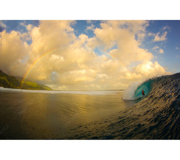 Famous surf photo with a rainbow and a surfer in Tahiti