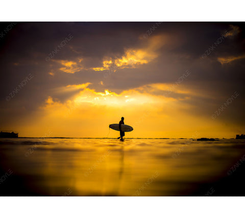 Photo of a surfer during sunset in Hawaii