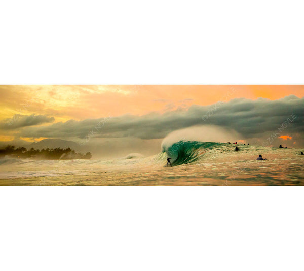 Sunset photograph of surfers on the North Shore of Oahu
