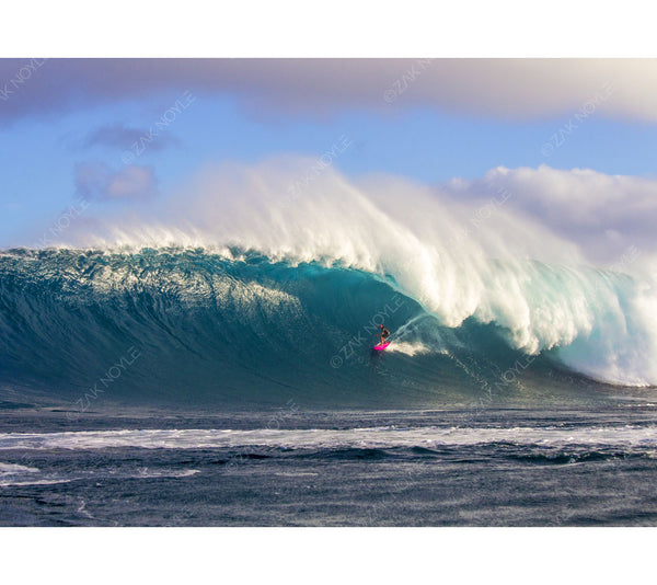 Photograph of a surfer on a large  wave