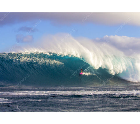 Photograph of a surfer on a large  wave