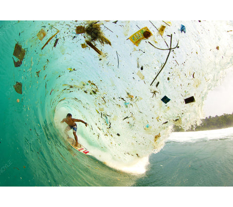 Image of a surfer in a wave full of trash in Indonesia